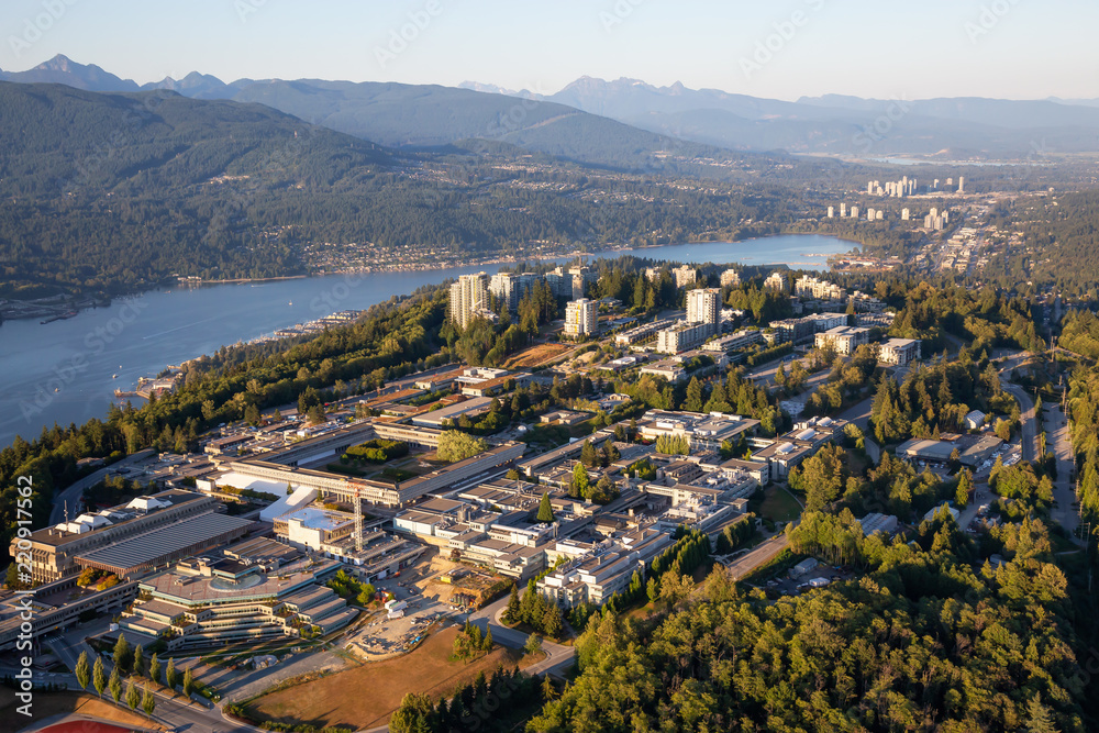 Aerial view of Burnaby Mountain during a vibrant sunny summer sunset. Taken in Vancouver, BC, Canada.
