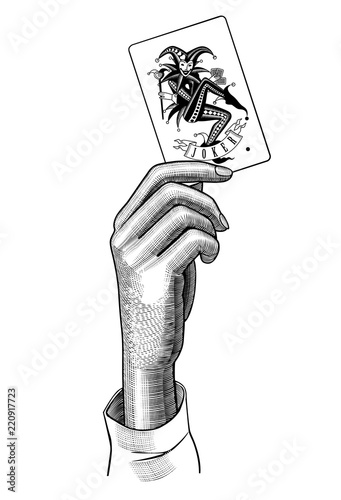 Female hand holding Joker playing card