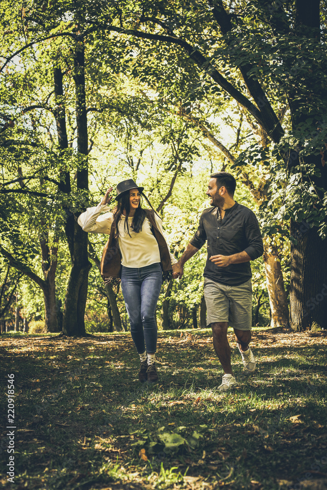 Happy couple outdoor. Walking trough woodland. Happy couple outdoor. Walking trough woodland.