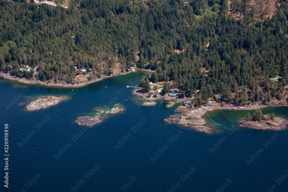 Fototapeta premium Aerial view of Rocky Islands near Madeira Park during a sunny summer day. Taken in Sunshine Coast, BC, Canada.