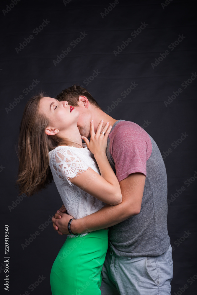 Lovers kissing each other on black background Lovers kissing each other on black background