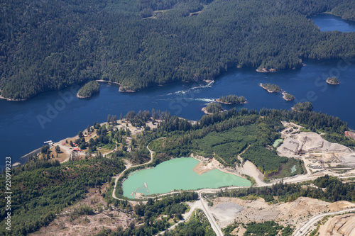 Aerial view of mining industry near Sechelt Inlet during a vibrant sunny day. Located in Sunshine Coast, BC, Canada. photo