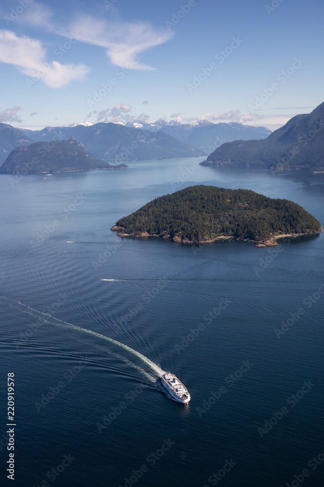 Fototapeta premium Howe Sound, Vancouver, BC, Canada - July 21, 2018: Aerial view of BC Ferry traveling in the ocean during a vibrant sunny summer day.