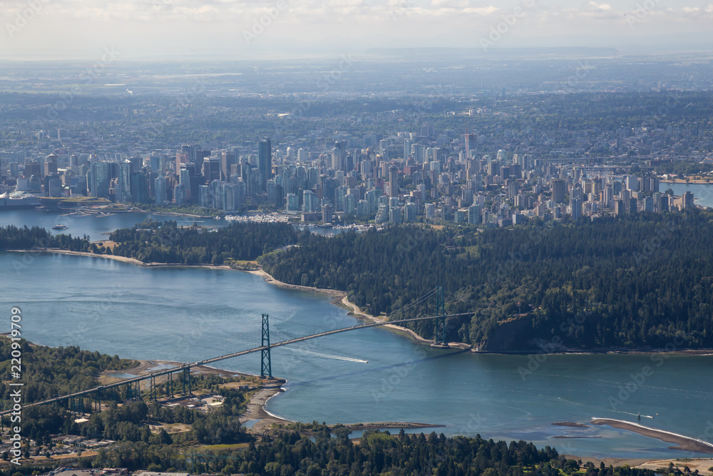Aerial view of Lions Gate, Stanley Park and Downtown City during a sunny summer day. Taken in Vancouver, BC, Canada.