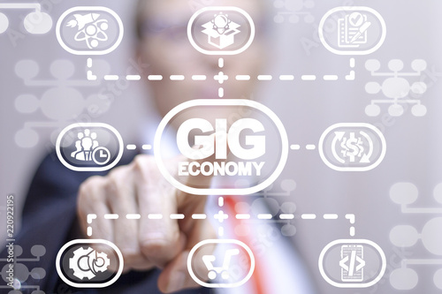 Man clicks a gig economy words button on a virtual scheme panel. GIG economy business finance marketing concept. photo