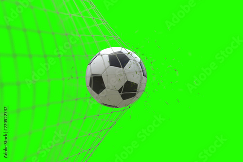 soccer ball in goal with grass leaves that raises effect on chroma key green screen background  concept of competition and leisure game equipment
