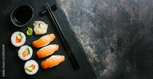 Sushi served on plate on dark table