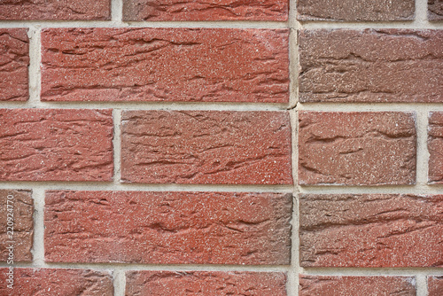 full frame view of red weathered brick wall, textured background