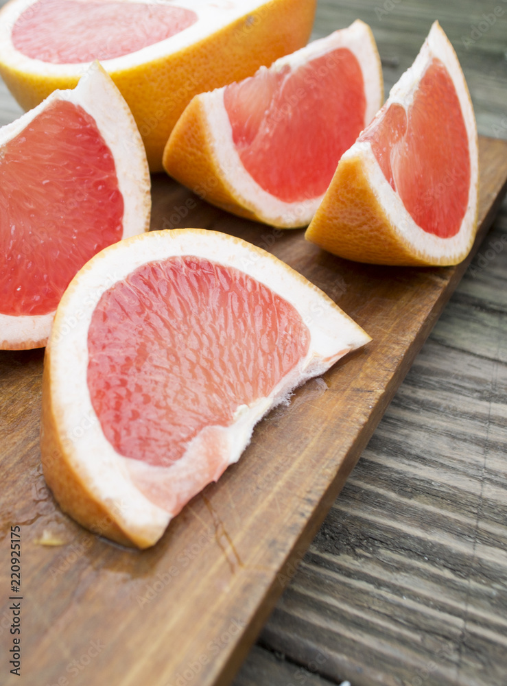 chopped citrus lobules against a tree background chopped citrus lobules against a tree background