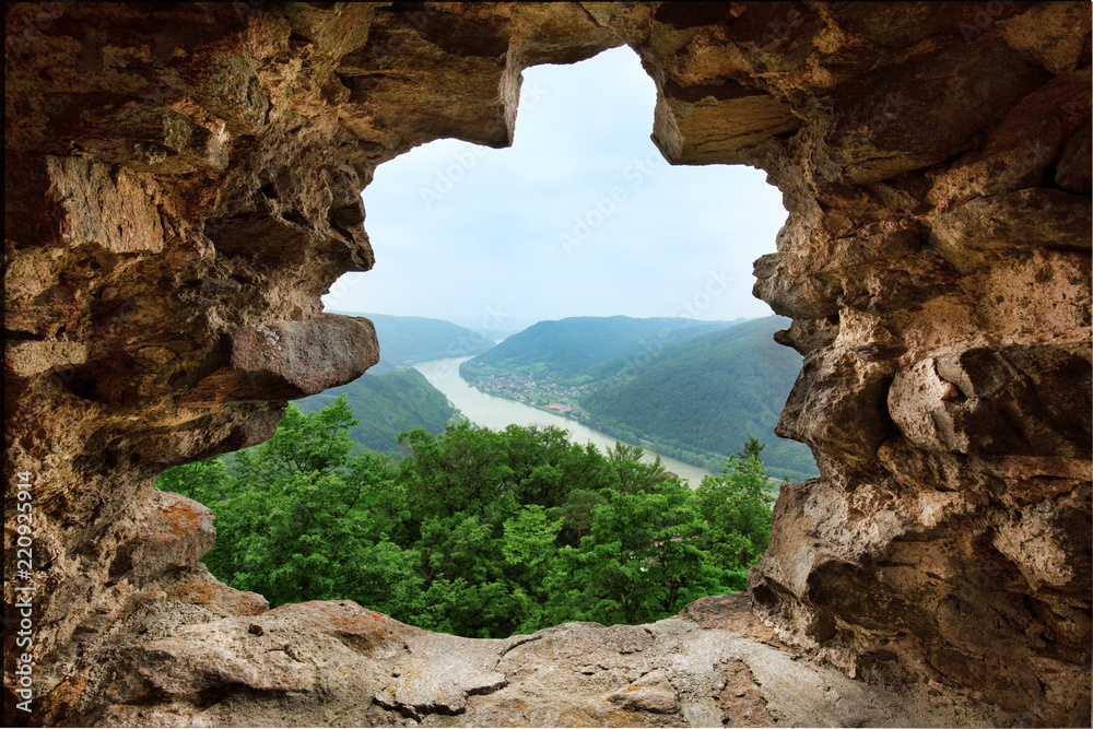 Aerial view to river valley through the window of old fortress