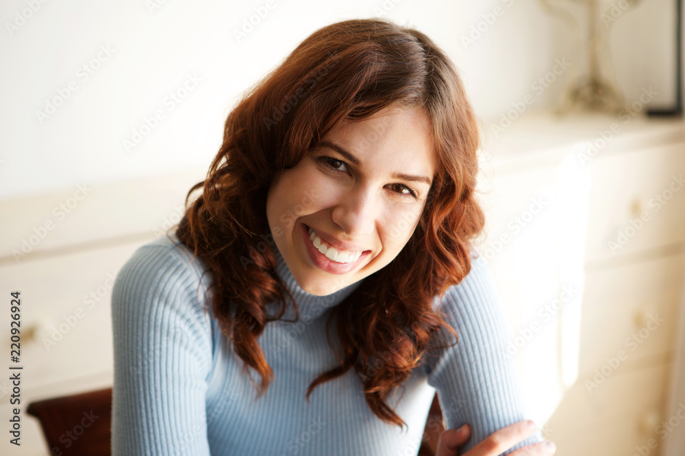 Close up young woman sitting and smiling Close up young woman sitting and smiling