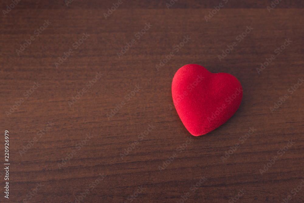 Red heart on a wooden background, concept of medicine or love Red heart on a wooden background, concept of medicine or love