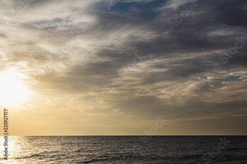 golden hour sunrise at sea, dark landscape