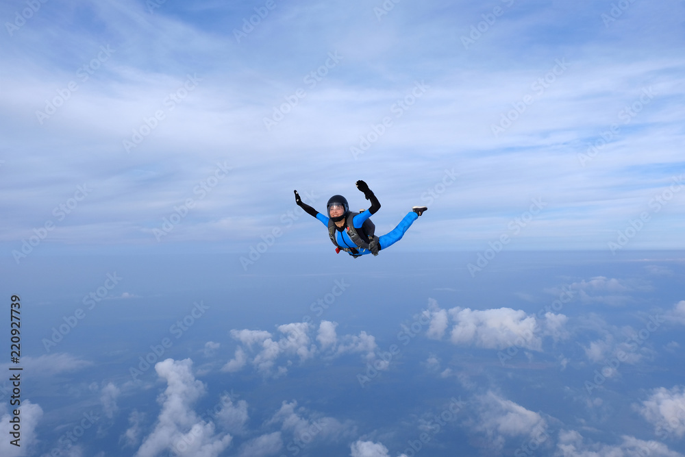 Skydiving. Girl is in the sky.