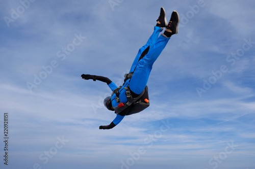 Skydiving. Girl is in the sky.