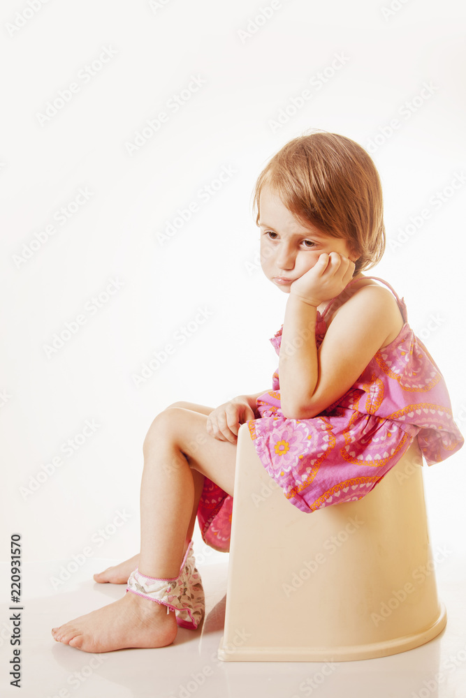 Potty Training. Little cute child girl sitting on a toilet. Stock
