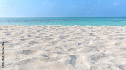 Abstract beach background. White sand, blue sky and calm tropical beach landscape. Exotic nature concept