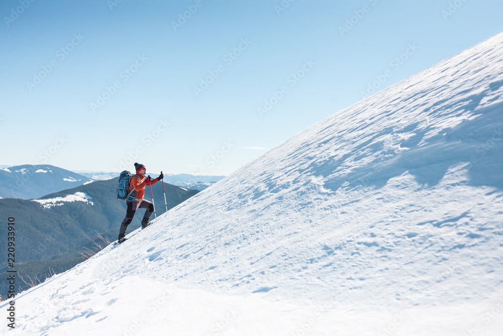 A man climbs to the top of the mountain.