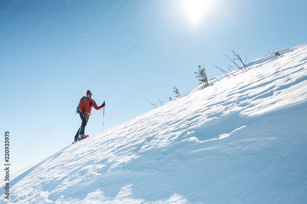 A man climbs to the top of the mountain. A man climbs to the top of the mountain.