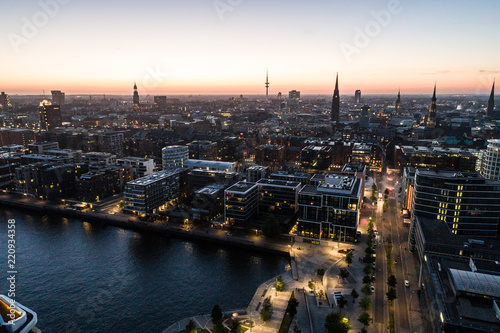 Aerial view of the harbor district  the concert hall  Elbphilharmonie  and downtown Hamburg  Germany  at dusk. 