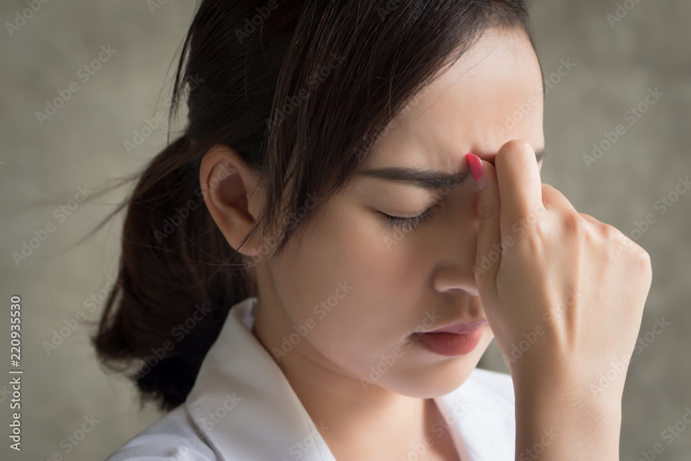 portrait of stressed and sick woman with headache; ill woman suffers from stress, vertigo, dizziness, migraine, hangover, health care concept; young adult asian woman model portrait of stressed and sick woman with headache; ill woman suffers from stress, vertigo, dizziness, migraine, hangover, health care concept; young adult asian woman model