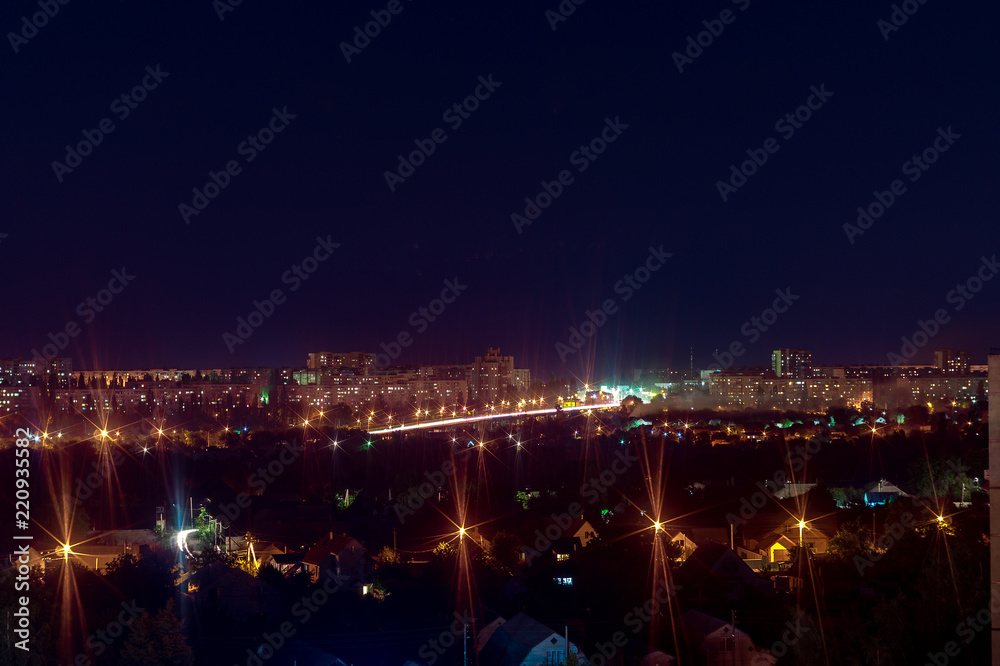 Long exposure night photo. A lot of lights symbolized Big city life at night. Night city illumination. Night cityscape.