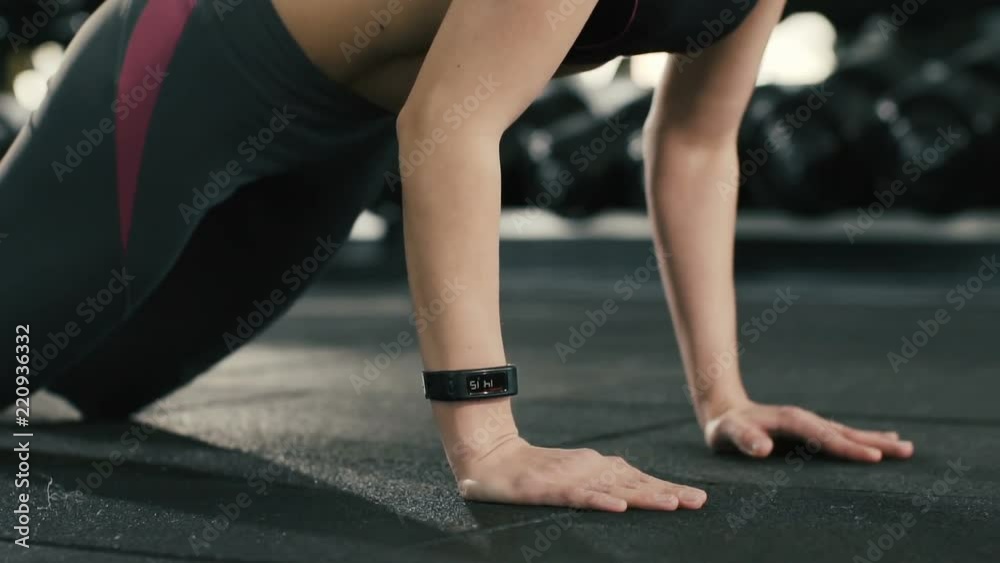 Pretty girl doing push ups at gym background Pretty girl doing push ups at gym background