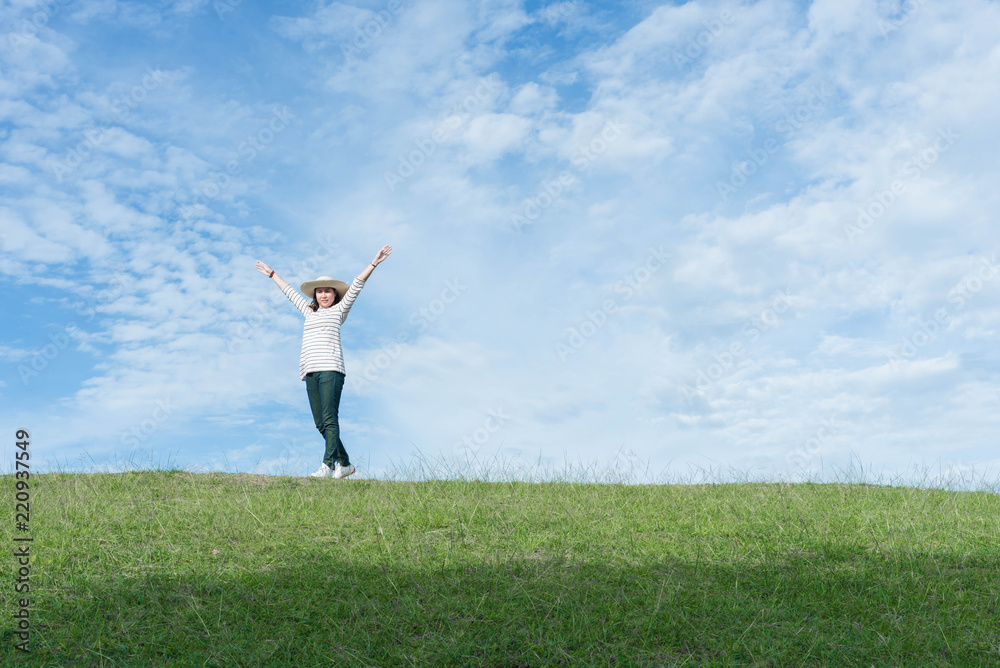 Standing woman raised her hands on the mountain, natural green and beautiful sky. Standing woman raised her hands on the mountain, natural green and beautiful sky.