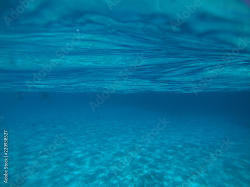 Sea level underwater photo of tropical caribbean paradise turquoise beach in exotic island located in an ocean