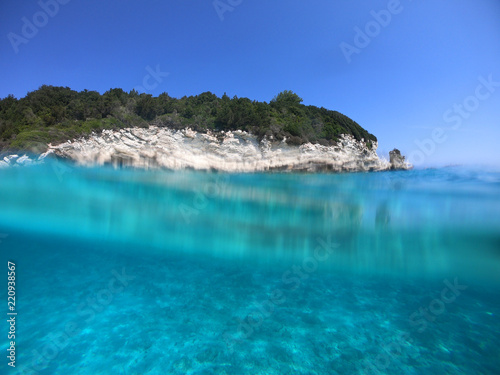 Sea level underwater photo of tropical caribbean paradise turquoise beach in exotic island located in an ocean