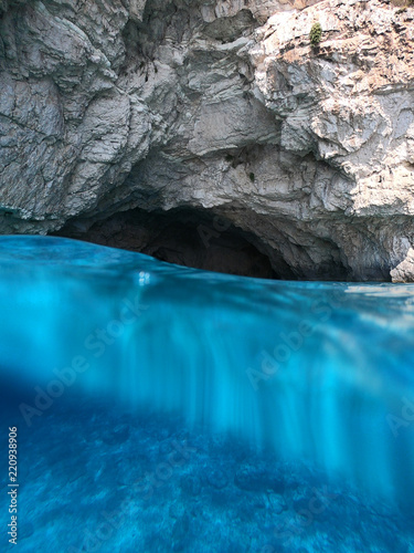 Underwater photo from amazing tropical paradise exotic caves in Blue Lagoon with deep blue ocean clear waters