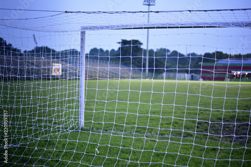 photograph is taken from behind the empty soccer goal