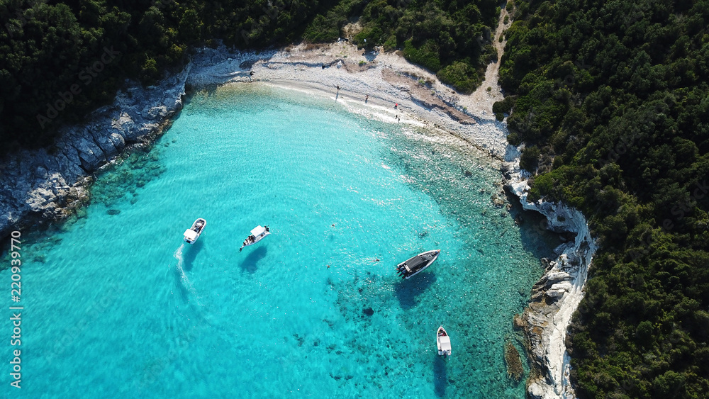 Aerial bird's eye view photo taken by drone of tropical rocky caribbean seascape with sandy beach with turquoise clear waters and small trees