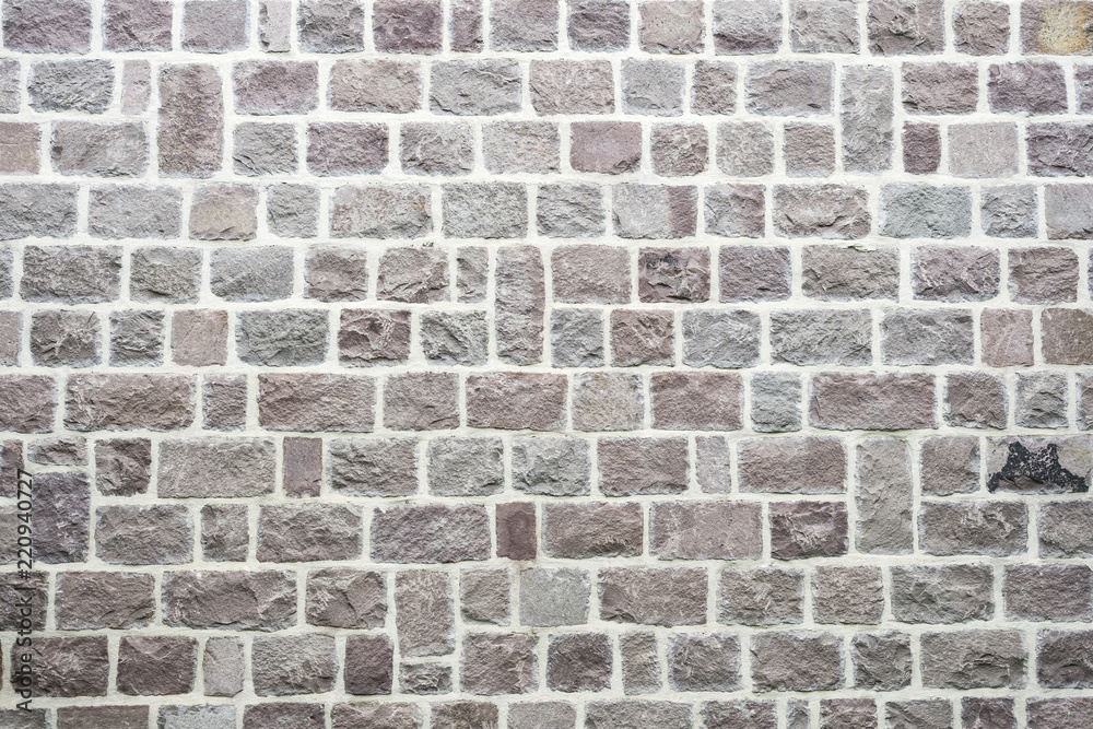 Fototapeta premium Texture of a stone wall. Old castle stone wall texture background. Stone wall as a background or texture. Part of a stone wall, for background or texture
