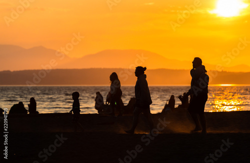 scene view of silhouette people on the beach with sunset on summer Seattle usa.