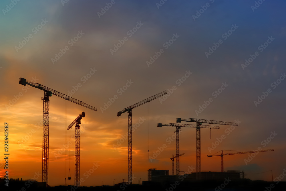 silhouette of construction and cranes in the evening on the sunset silhouette of construction and cranes in the evening on the sunset