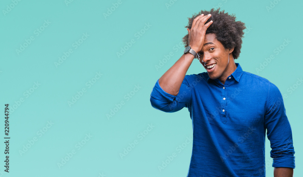 Afro american man over isolated background surprised with hand on head for mistake, remember error. Forgot, bad memory concept. Afro american man over isolated background surprised with hand on head for mistake, remember error. Forgot, bad memory concept.