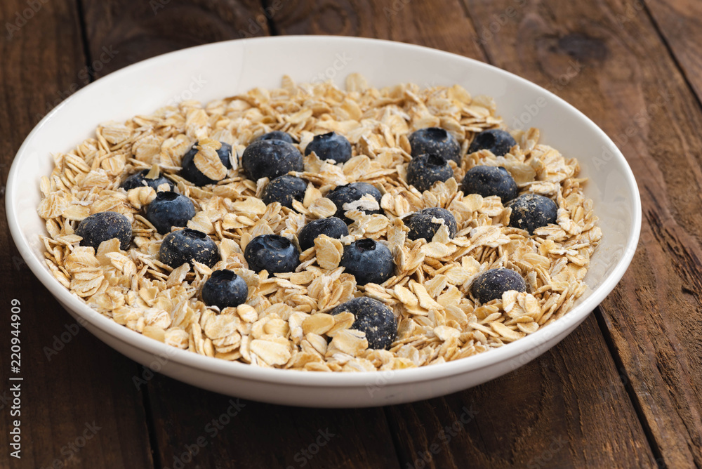 Granola, oatmeal with blueberry on white plate