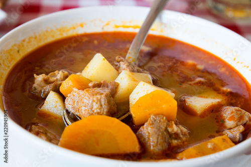 Photography Hot meat goulash soup with paprika, potatoes and pieces of dough (dumplings) is