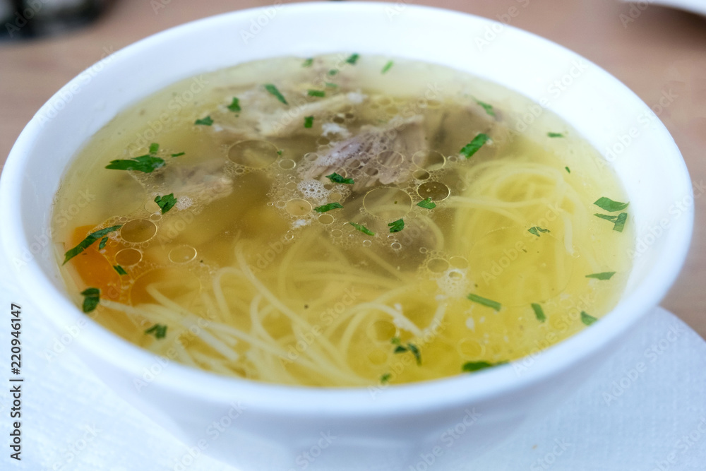 Rich beef bouillon with homemade pasta, vegetables and herbs Rich beef bouillon with homemade pasta, vegetables and herbs