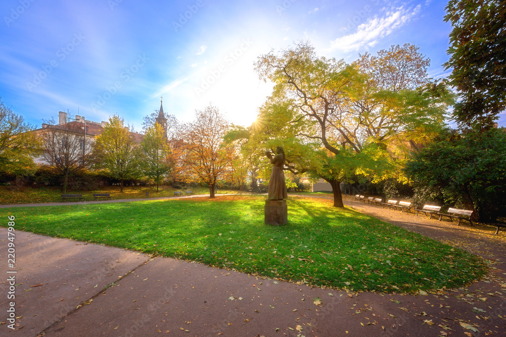 Prague autumn park bright color landscape. Sculpture of a women with a dove in the city park near the Castle Hill, Prague, Czech Republic, travel Europe