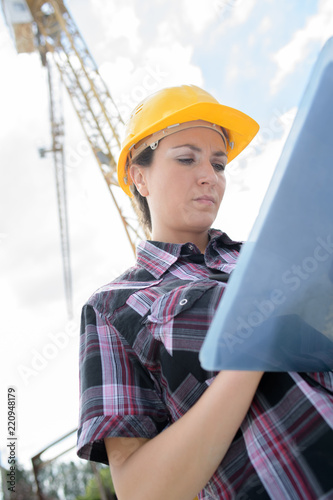 female contractor at a work site using an ipadtablet photo