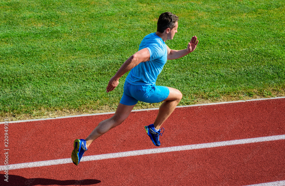Obraz premium Athlete run track grass background. Sprinter training at stadium track. Progress and achievement. Training before take part in marathon. Man captured in motion. Sprinter athlete run training