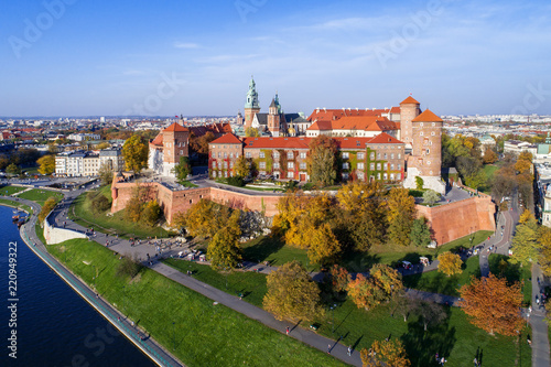 Krakow, Poland, with royal Wawel castle, cathedral and Vistula river in autumn. Aerial skyline panorama at sunset.
