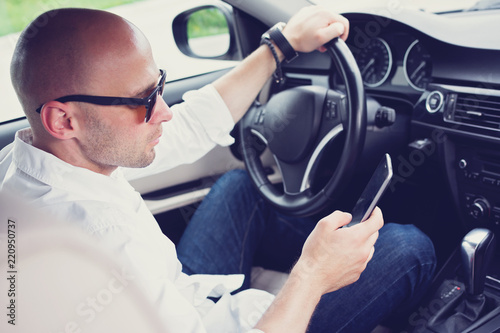 Photos Young man texting and driving