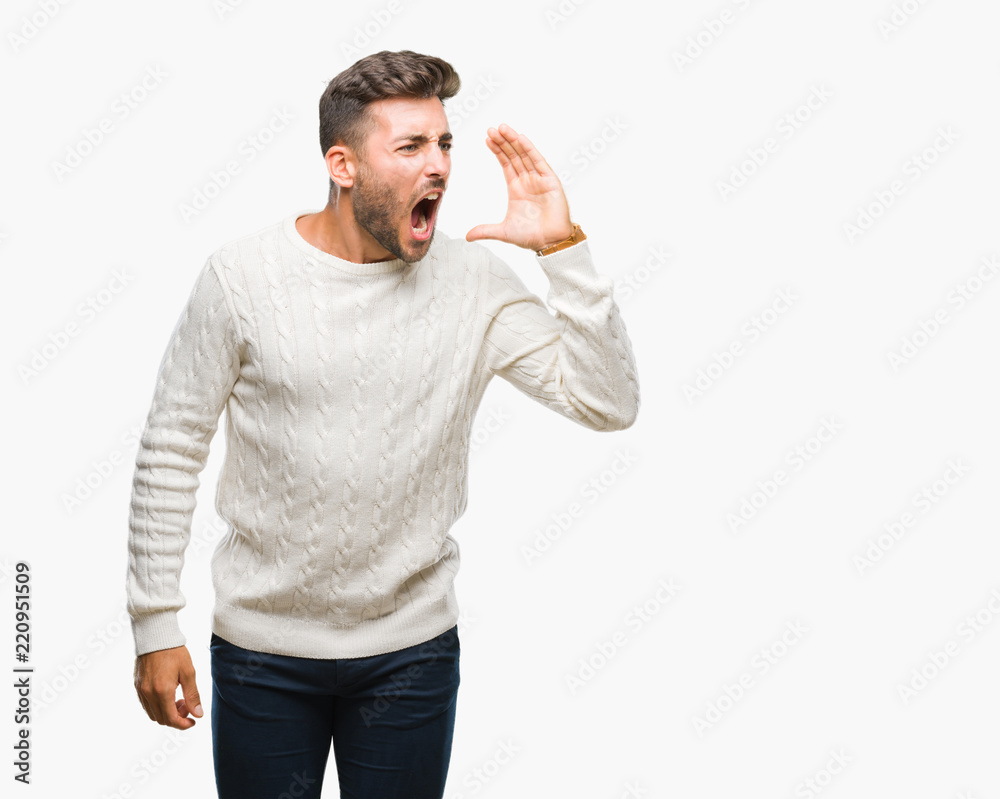 Young handsome man wearing winter sweater over isolated background shouting and screaming loud to side with hand on mouth. Communication concept. Young handsome man wearing winter sweater over isolated background shouting and screaming loud to side with hand on mouth. Communication concept.