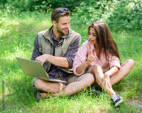 Closer to nature. Modern technologies give opportunity to be online and work in any environment conditions. Man and girl looking at laptop screen. Couple youth spend leisure outdoors with laptop © be free