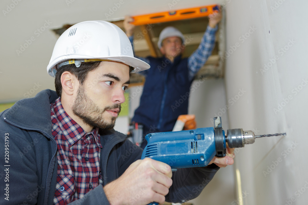 worker is drilling concrete wall construction site worker is drilling concrete wall construction site
