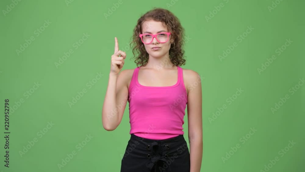 Young beautiful nerd woman pointing finger up