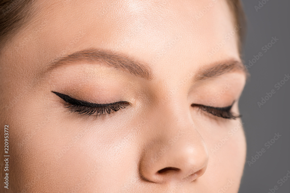 Fototapeta premium partial view of woman with black eyeliner on eyelids